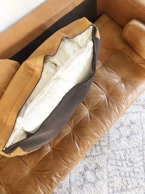Sagging leather sofa cushion being reshaped and rebuilt in San Antonio, Texas.
